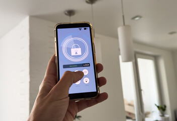 smart house, home automation, device with app icons. Man uses his smartphone with smarthome security app to unlock the door of his house.