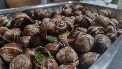 Close-up of baked snails with spinach.