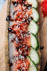 sushi dog, rolls with rice, nori, salmon, unagi sauce, sesame, fresh cucumber, with ginger, wasabi, soy sauce, flatlay, Japanese food, fast food, snacks