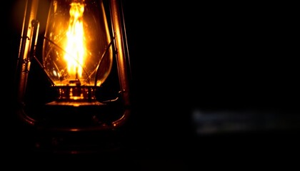 Warm glow of vintage oil lantern casts an enchanting light in the dark solitude