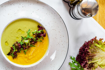 Bowl with Pumpkin cream soup and green bean soup. for vegetarians
