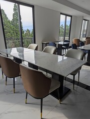 empty tables and chairs in the restaurant, A luxurious restaurant with an open-air atmosphere, featuring stunning views of the surrounding environment.