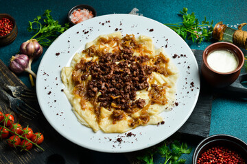 Dumplings with cracklings in a plate. Free space for text. Close up. © Yaruniv-Studio