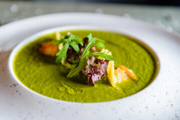 Broccoli cream soup and ingredients on table