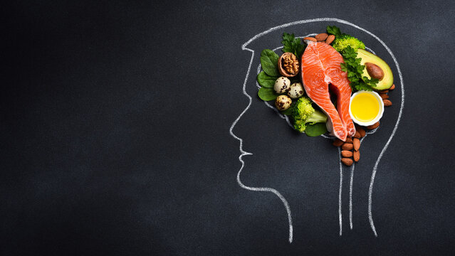 healthy food for brain functions and memory, mental wellness. Chalk drawing of brain on black chalkboard, top view