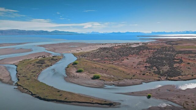 Argentine Archipelago. From this aerial perspective, the pristine beaches, the crystal-clear waters, and the towering mountains create an unforgettable spectacle, further enhanced by the clouds above.