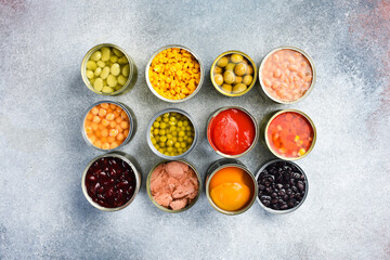 Set of canned preserves food in tin open cans. Food stocks. Side view.