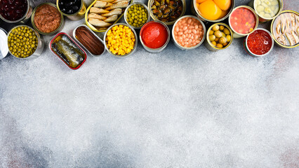 Set of canned preserves food in tin open cans. Food stocks. Side view.