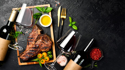 Bottled wine and Beef T-bone steak. Prime Black Angus beef steak and aged wine. Top view.