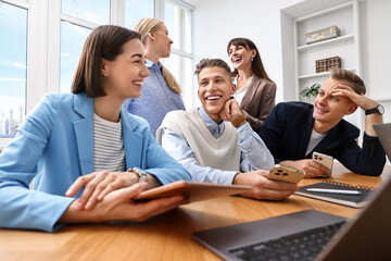 Obraz premium Group of people using different gadgets at wooden table in office. Modern technology