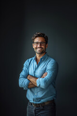 Fototapeta premium Portrait of happy fashionable handsome man in jeans shirt and glasses crossing hands and smiling