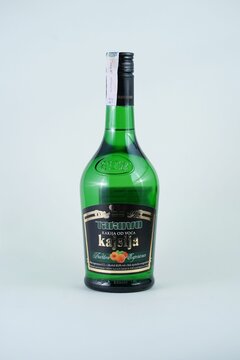 a green bottle of kerstin on a table with its cap slightly upside