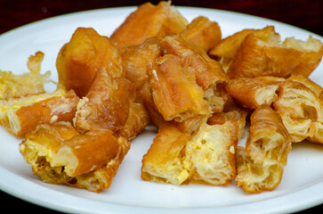 Close up of cut cakoi or youtiao cake on white plate