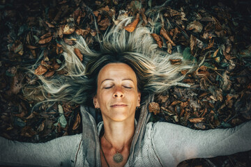 A Woman Joyfully Embracing the Beauty of Nature While Surrounded by Autumn Leaves