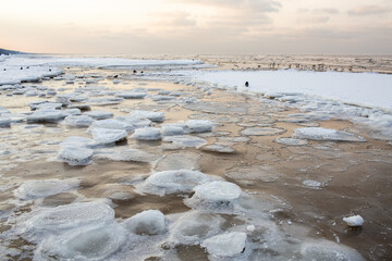 Frozen seascape with ice formations on a winter beach