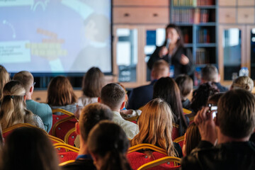 Obraz premium Audience sitting attentively during a presentation focusing on speaker and displayed content