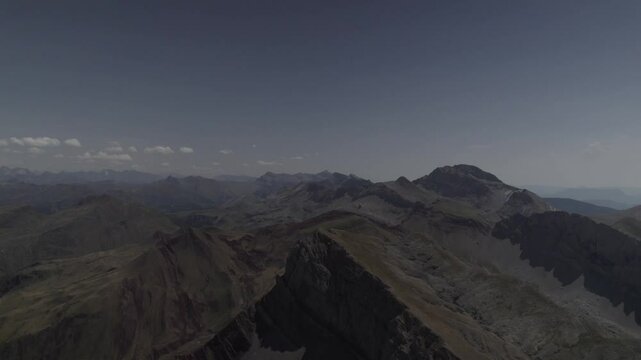 This drone video features a stunning descriptive reverse shot, flying away from the imposing Pico del Castillo d&rsquo;Acher in the Aragonese Pyrenees, Spain, revealing its breathtaking mountain landscapes.