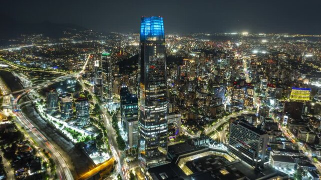 Aerial hyperlapse fly Santiago de Chile downtown, illuminated city, Costanera tower, traffic at South American andean Capital