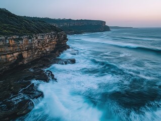 Dramatic Coastal Cliffs at Dusk with Crashing Waves and Soft Pastel Sky.