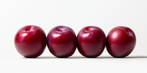 Fresh sweet red plums showcased on a pristine white background, highlighting the vibrant color and juicy texture of these delicious sweet red plums, perfect for culinary use or artistic displays.