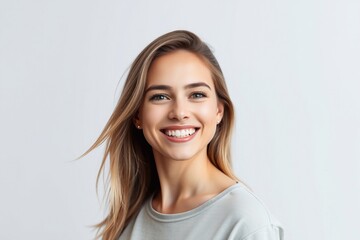 Naklejka premium Pretty smiling joyfully female with fair hair, dressed casually, looking with satisfaction at camera, being happy. Studio shot of good-looking beautiful woman isolated against blank studio wall. 