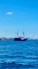 Traditional phinisi boat in the ocean near Komodo Islands, Indonesia. A journey through stunning waters.