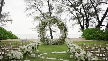 Wedding event decor beach luxury flowers Beautiful Wedding event decoration beautiful arch decorated with flowers,white roses on wedding chairs