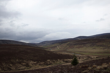 Scenic views of the Scottish Highlands capturing the dramatic landscape and cloudy sky in late afternoon light