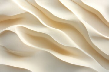 Fototapeta premium Abstract image of soft, flowing, creamy beige waves creating a textured background.