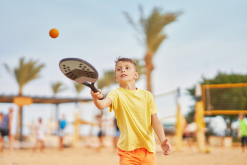 Boy playing beach tennis in Egypt Hurghada