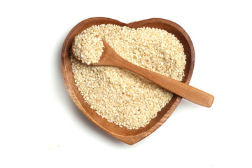 bowl with sesame seeds in heart shape on white background