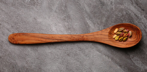 wooden spoon with shelled pistachios