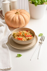Quinoa vegetable salad on white wooden table. Vegetarian and diet food