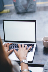 Fototapeta premium Unrecognizable couple of freelancers with laptop and smartphone drinking coffee
