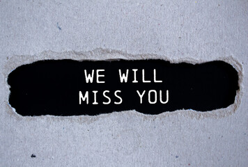 We will miss you message written on ripped torn gray paper with black background. Conceptual we...