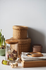 sewing threads on vintage rustic wooden spools with other accessories in jar