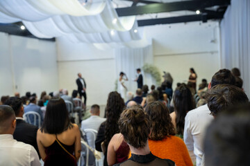 Fototapeta premium guests watching at a wedding a ceremony celebrating with the husband and bride