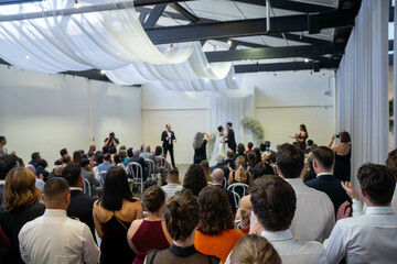 Fototapeta premium guests watching at a wedding a ceremony celebrating with the husband and bride