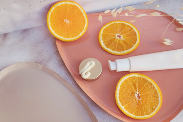 Vitamin C face cream and  orange  fruit slices