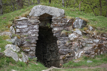 Exploring an ancient stone structure in the lush Scottish countryside during springtime
