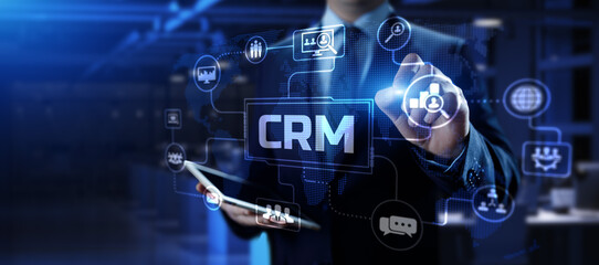 CRM Customer relationship management concept. Businessman pressing button on screen.