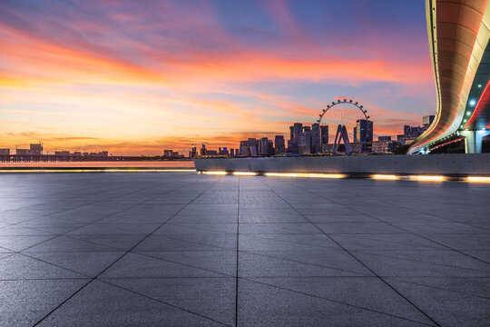 Empty square floor with modern city buildings scenery at sunset. Outdoor city background.