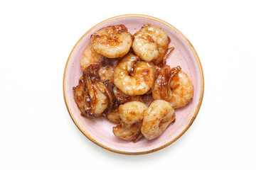 Shrimps on a small plate. Seafood snack with a sweet touch. Honey chili shrimp background. Crispy and delicious food isolated on a white background. Fried prawns dinner meal. Flat lay top view.