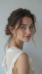 A beautiful young woman with captivating blue eyes and a gentle smile gazes over her shoulder, exuding warmth and charm. Her soft, flowing hair and delicate attire enhance the serene atmosphere