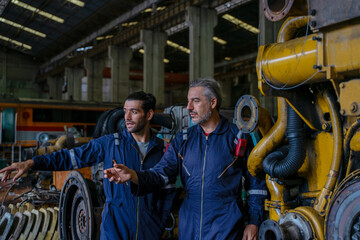 Technicians work at train engine repair shop.