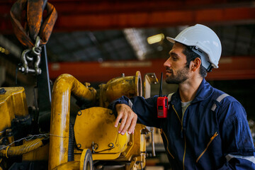 Technicians work at train engine repair shop.