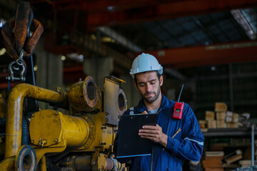 Technicians work at train engine repair shop.