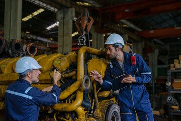 Technicians work at train engine repair shop.