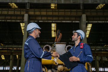 Technicians work at train engine repair shop.