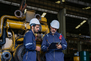 Technicians work at train engine repair shop.